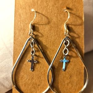 Teardrop shaped silver cross earrings.